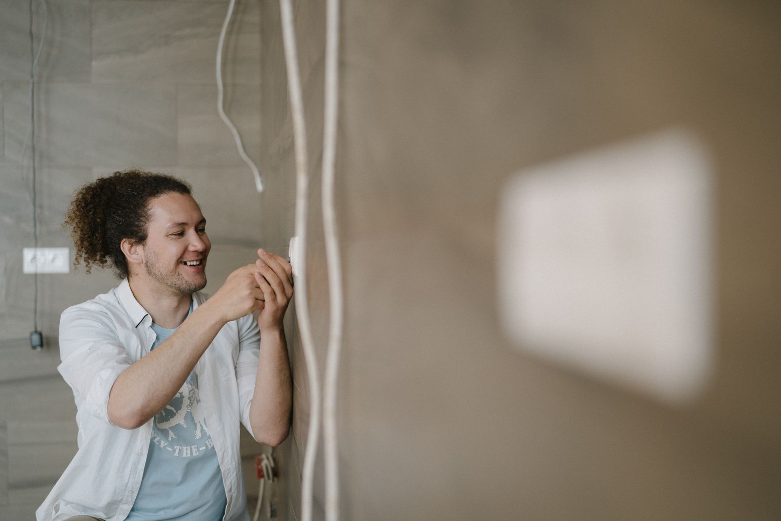 An electrician finishing an outlet